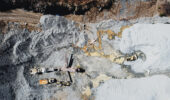 Looking down on a gravel quarry with rock crusher & equipment.
